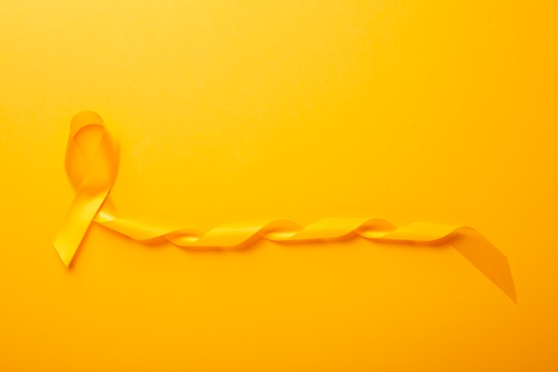 View of yellow ribbon on yellow background