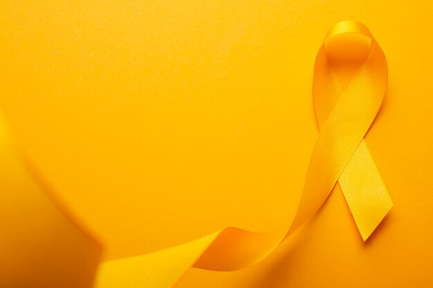 View of yellow ribbon on yellow background