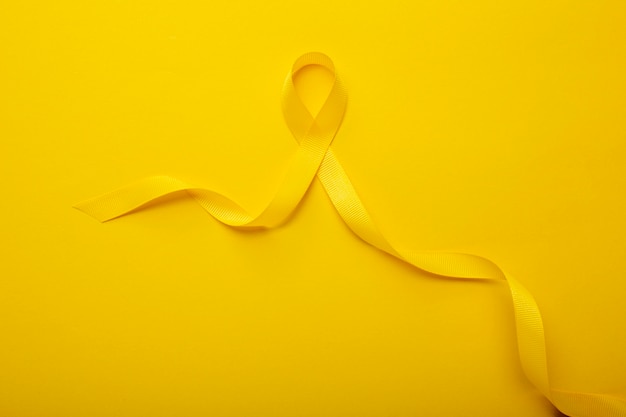 View of yellow ribbon on yellow background