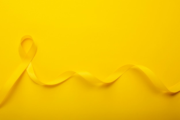 View of yellow ribbon on yellow background