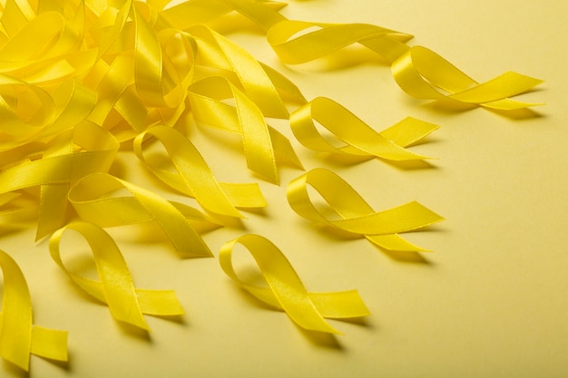 Free photo view of yellow ribbons on yellow background