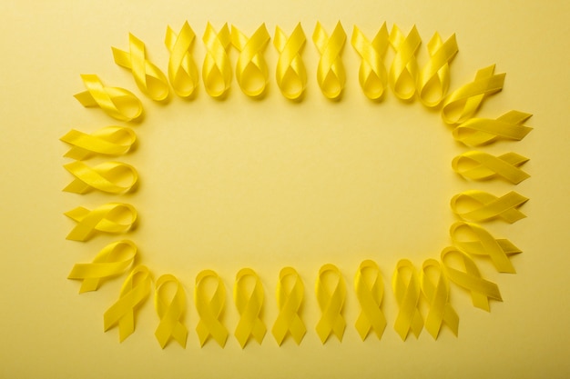 Free photo view of yellow ribbons on yellow background