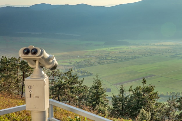 Viewing telescope on Slivnica mountain viewing deck overlooking a valley