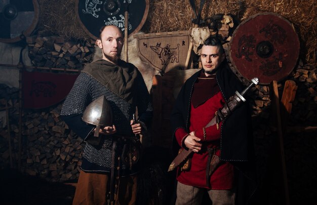 Vikings posing against the ancient interior of the Vikings.