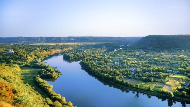 Village with orthodox church, river dividing into two parts