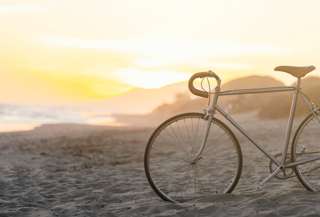 Vintage bicycle on sand at beach