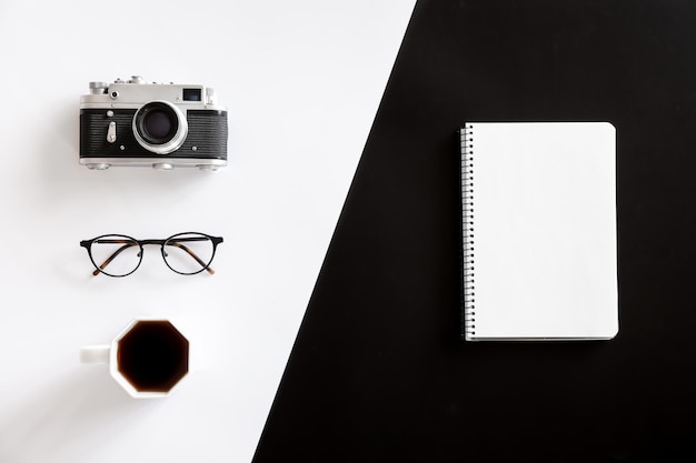 Free photo vintage camera coffee cup glasses and notepad flat lay