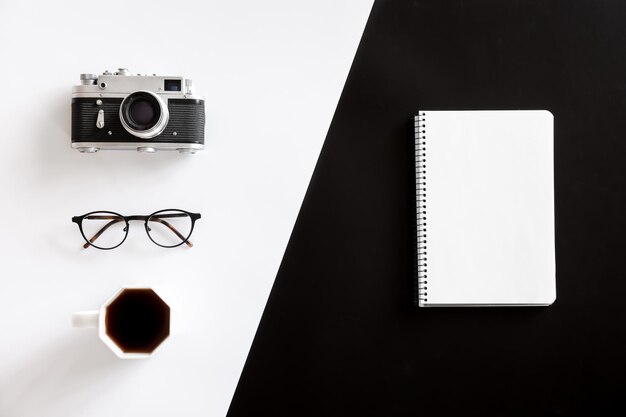 Vintage camera coffee cup glasses and notepad flat lay