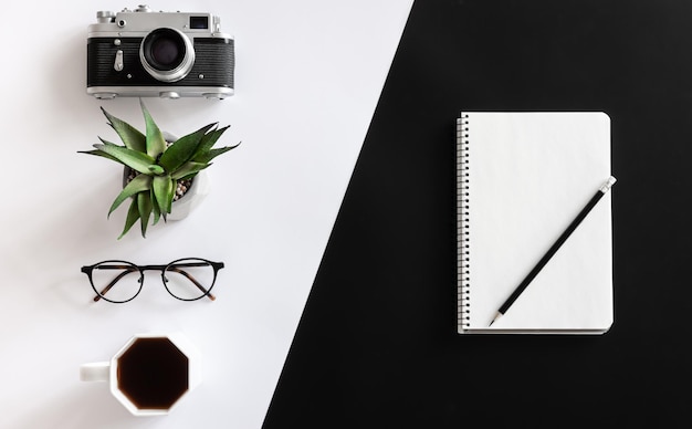 Free photo vintage camera coffee cup glasses and notepad flat lay