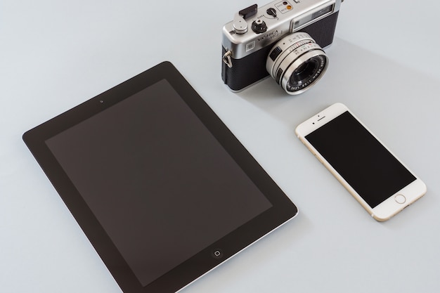 Free photo vintage camera with tablet and mobile