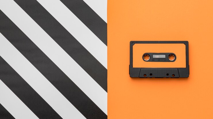 Free Photo vintage cassette tape on orange and striped background