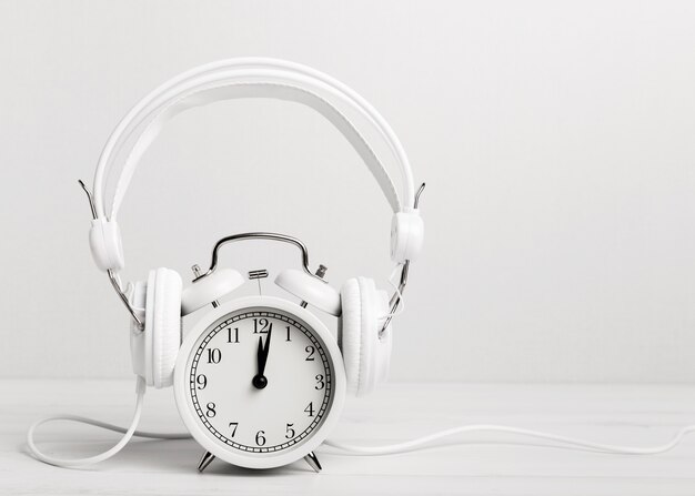 Vintage clock listening music through headphones