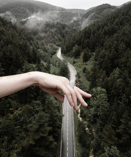 Free photo vintage collage with hand holding road