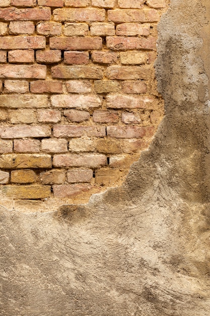 Free photo vintage concrete wall with exposed bricks