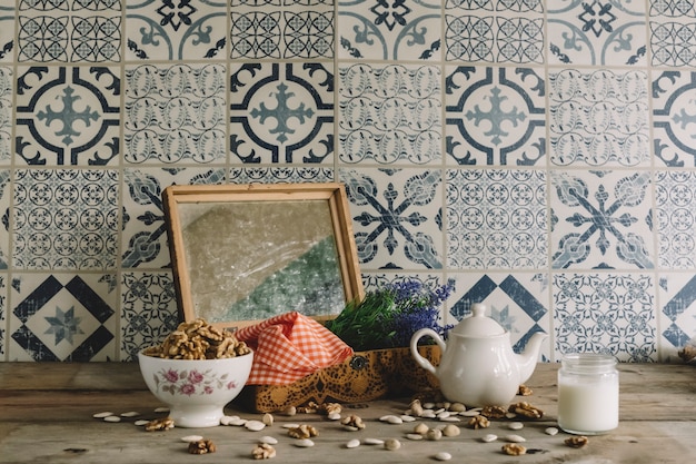 Vintage decoration with frame, nuts and tea pot