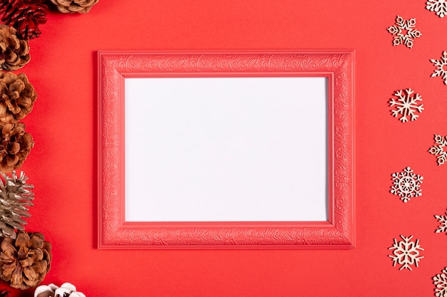 Vintage frame and snowflakes on red table