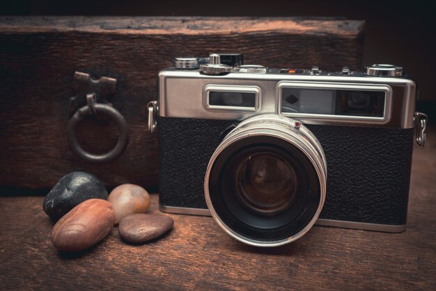 Free photo vintage front and natural stones on a wooden table near the old chest