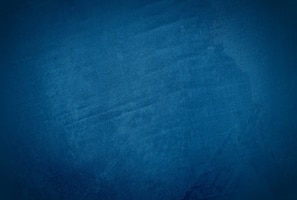 Vintage grunge blue concrete texture studio wall background with vignette.