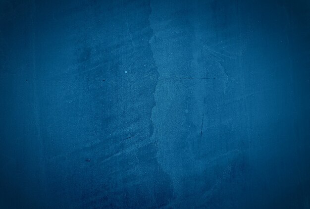 Vintage grunge blue concrete texture studio wall background with vignette.