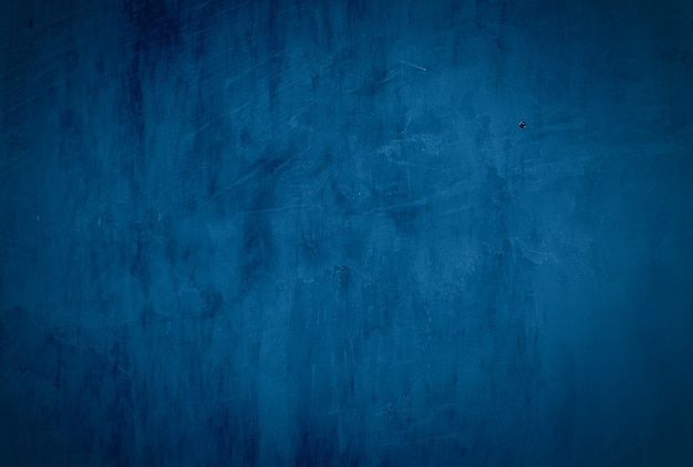 Vintage grunge blue concrete texture studio wall background with vignette.