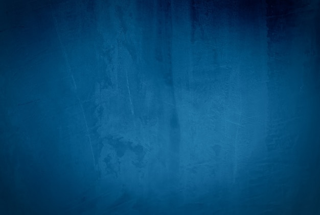 Vintage grunge blue concrete texture studio wall background with vignette.