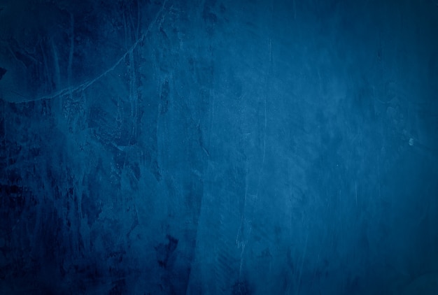 Vintage grunge blue concrete texture studio wall background with vignette.