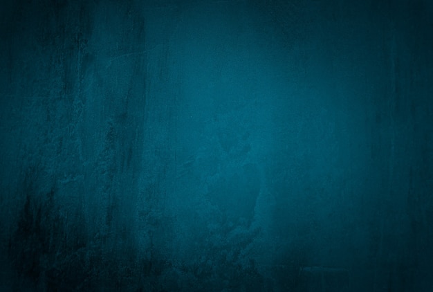 Vintage grunge blue concrete texture studio wall background with vignette.