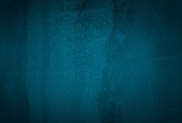 Vintage grunge blue concrete texture studio wall background with vignette.