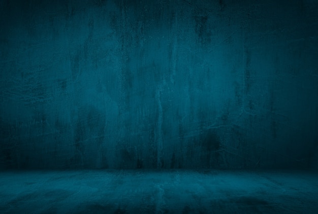 Free photo vintage grunge blue concrete texture studio wall background with vignette.