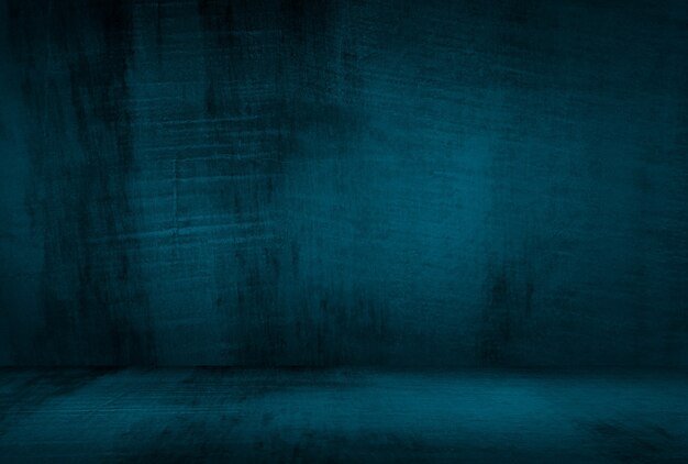 Vintage grunge blue concrete texture studio wall background with vignette.