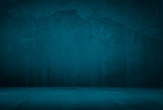 Vintage grunge blue concrete texture studio wall background with vignette.