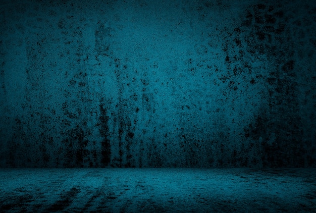 Vintage grunge blue concrete texture studio wall background with vignette.