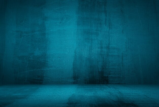 Vintage grunge blue concrete texture studio wall background with vignette.