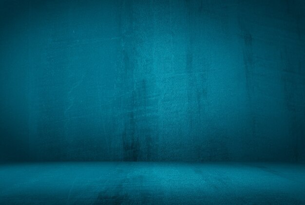 Vintage grunge blue concrete texture studio wall background with vignette.