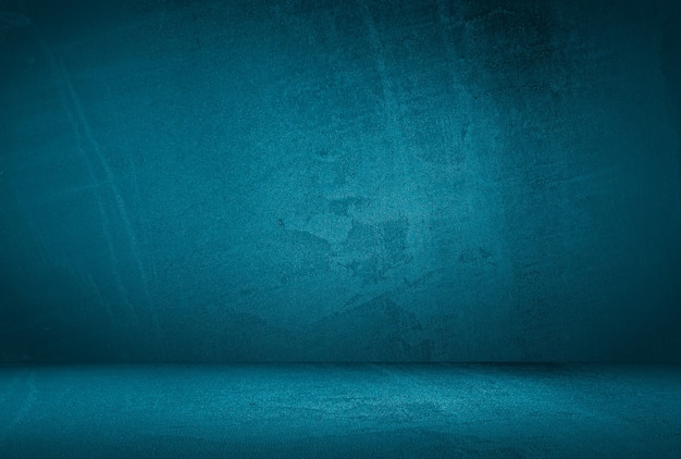 Free photo vintage grunge blue concrete texture studio wall background with vignette.