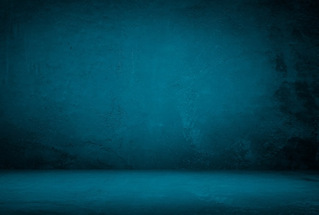 Free photo vintage grunge blue concrete texture studio wall background with vignette.