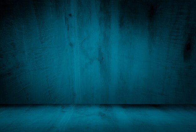 Vintage grunge blue concrete texture studio wall background with vignette.