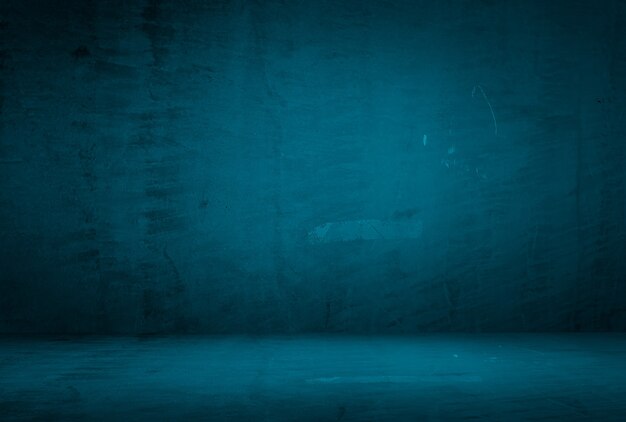 Vintage grunge blue concrete texture studio wall background with vignette.