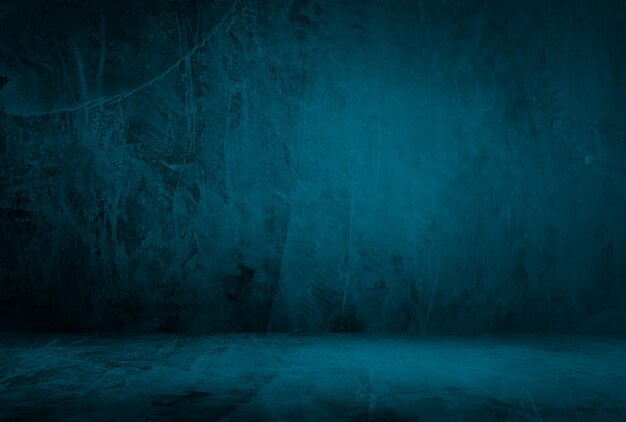 Vintage grunge blue concrete texture studio wall background with vignette.