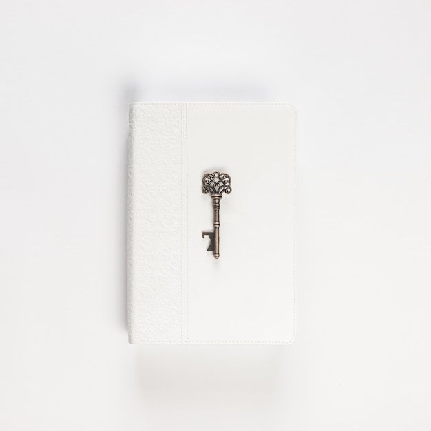 Vintage key on white book on white
