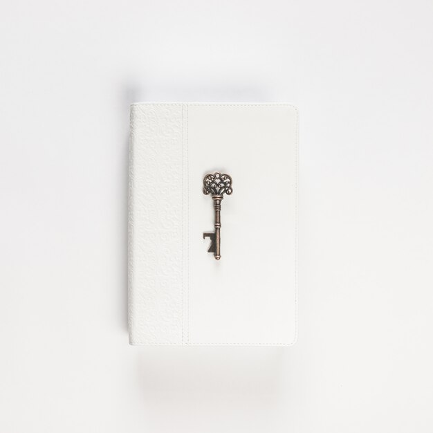 Vintage key on white book on white