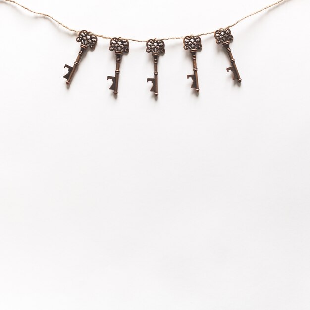 Vintage Keys Hanging On White Background