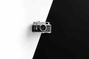 Free photo vintage retro camera on black and white background flat lay