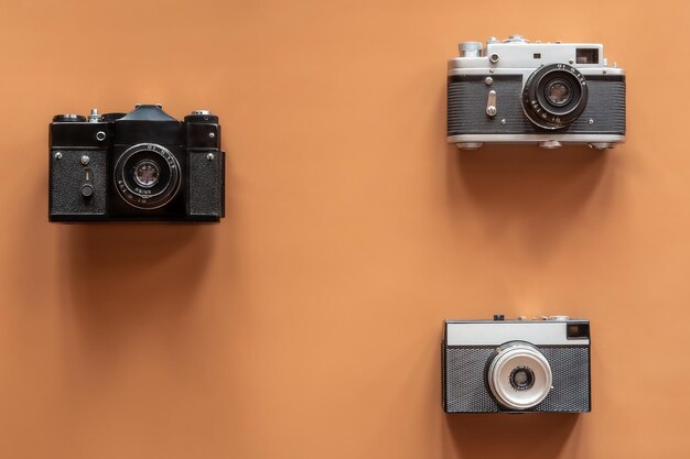 Vintage retro cameras on colored background flat lay