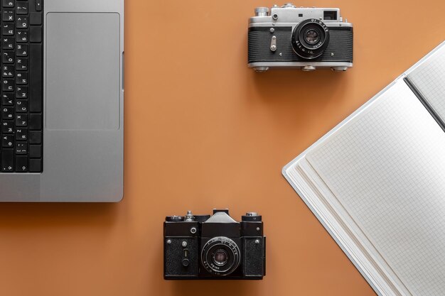 Vintage retro cameras on colored background flat lay