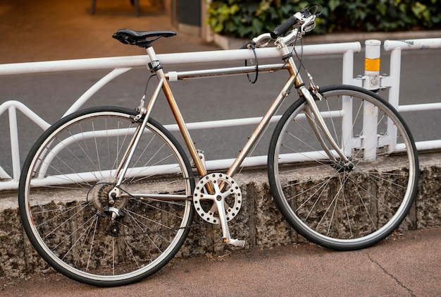 Vintage rusty bicycle near fence