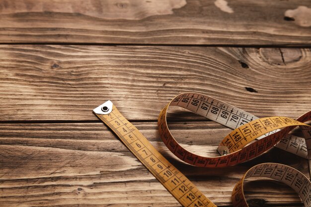 Vintage tailor ruler isolated on down part of aged wooden table