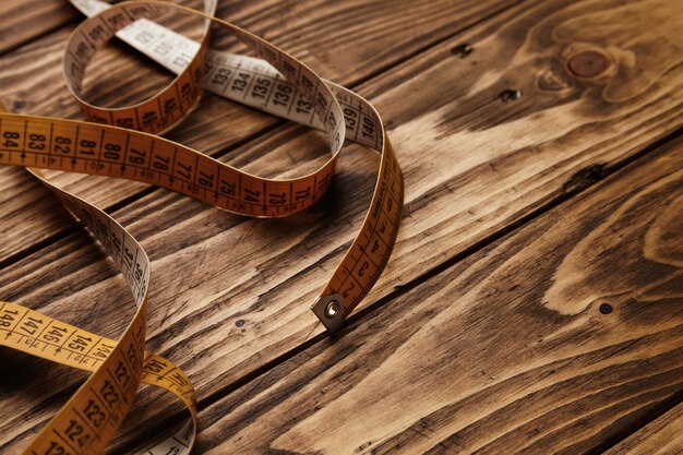 Vintage tailor ruler isolated on rustic wooden table