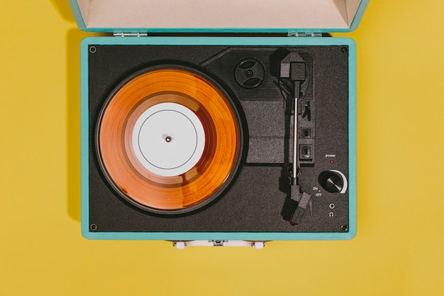 Vintage turntable with yellow surface
