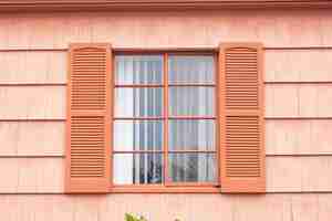 Free photo vintage window with orange tone wall